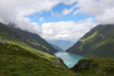 Scenic view of lake and mountains against sky