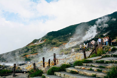 Scenic view of mountains against cloudy sky