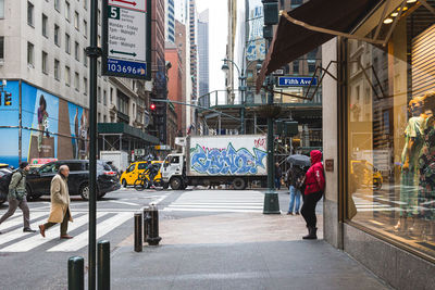 People walking on street in city