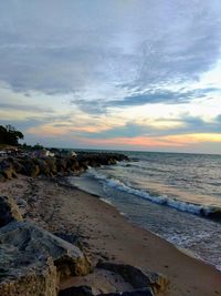 Scenic view of beach against sky during sunset