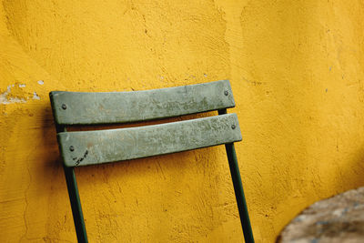 Close-up of window against yellow wall