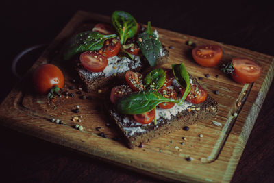 Sandwich with cream cheese, cherry tomatoes, spinach and spices. delicious healthy veggie food. 