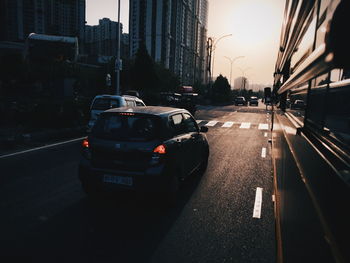 Traffic on city street during sunset