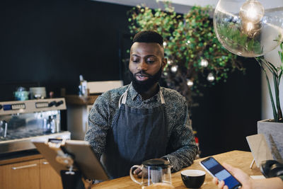 Portrait of young man sitting at table