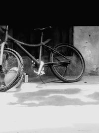 Bicycle parked against wall in city