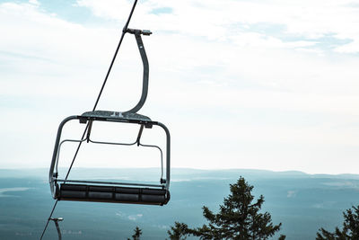 Low angle view of ski lift against sky