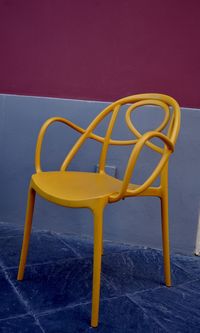 Yellow  chair against blue background bauhaus scenario