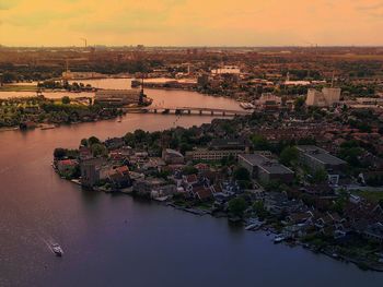 Aerial view of city against sky during sunset