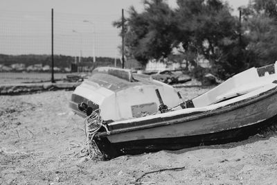 Abandoned toy car on field against sky