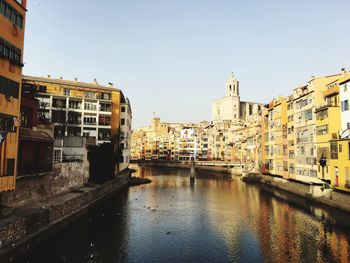 Canal amidst buildings against sky