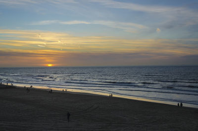 Scenic view of beach against sky during sunset