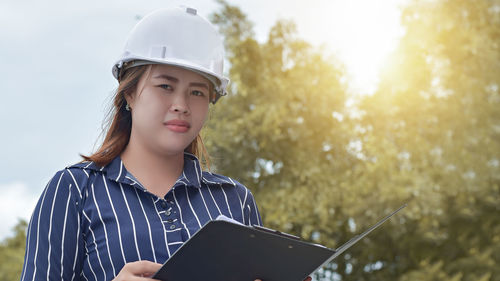 Portrait of smiling female architect standing outdoors