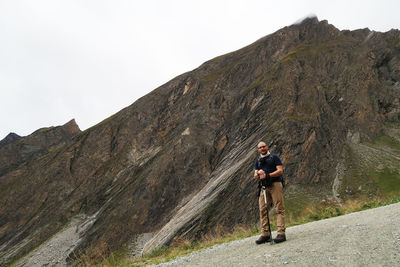 Man standing by mountain