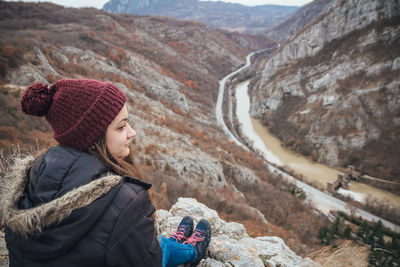 Portrait of young woman looking at mountains