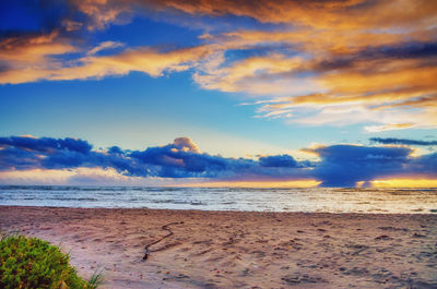 Scenic view of beach against sky during sunset