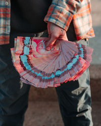 Teenager in plaid hoodie holding a lot of canadian money bills 