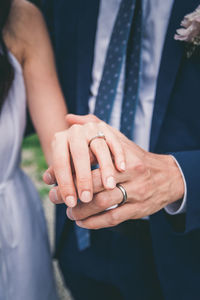 Midsection of couple holding hands