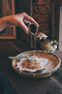 Midsection of person preparing food in tray
