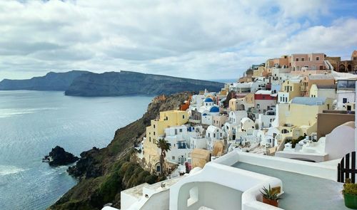 High angle view of townscape by sea against sky