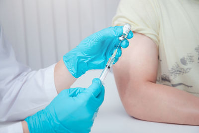 Close-up of person holding syringe