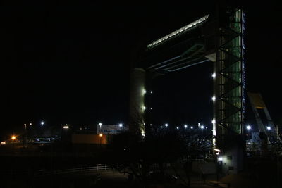 Illuminated city against sky at night