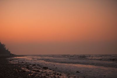 Scenic view of sea against orange sky