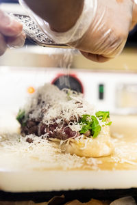 Cropped hand of person preparing food