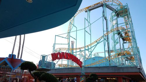 Low angle view of amusement park ride against sky