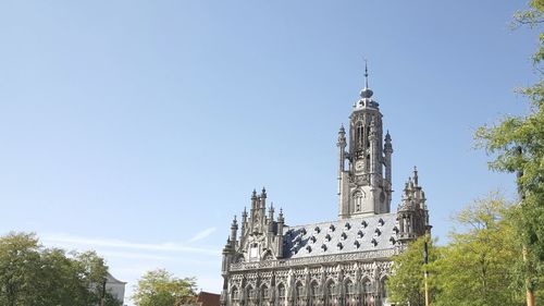 Low angle view of bell tower against sky