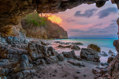 Scenic view of beach against sky during sunset