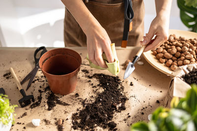 Female gardener hands cleans garden tools after transplanting plants