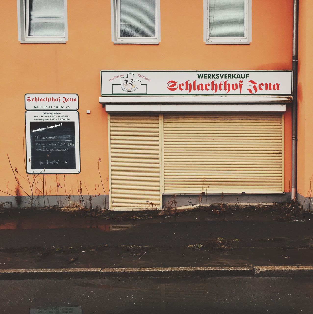 building exterior, architecture, built structure, text, communication, western script, transportation, information sign, yellow, sign, street, capital letter, guidance, outdoors, road sign, day, building, closed, no people, door