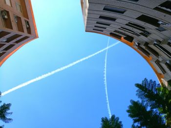 Low angle view of vapor trails in sky