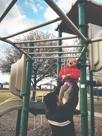 View of ferris wheel against cloudy sky