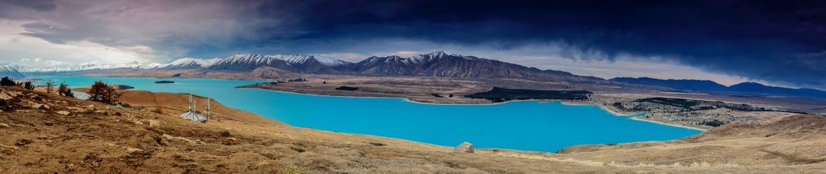Panoramic view of mountains and lake against sky