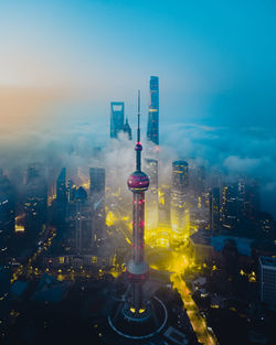 High angle view of illuminated buildings against sky at dusk