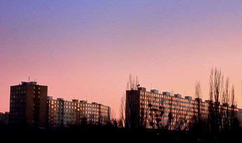 Silhouette buildings against sky during sunset