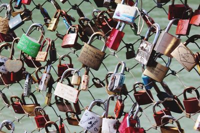 Close-up of padlocks hanging on fence