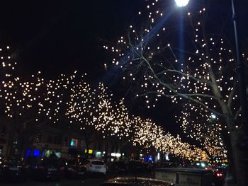 Illuminated firework display at night