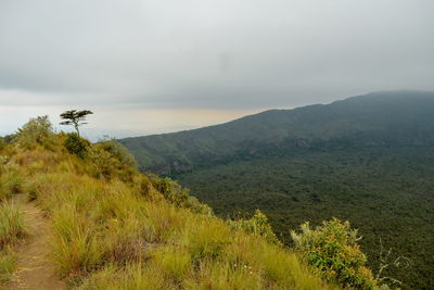 Scenic volcanic crater against a mountain background, mount longonot, rift valley, kenya