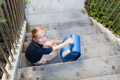 High angle view of boy standing on steps