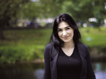 Portrait of smiling young woman standing outdoors