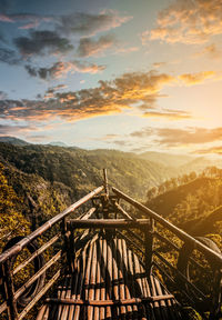 Low angle view of built structure against mountains during sunset