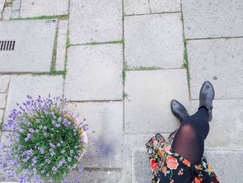 Low section of woman standing on tiled floor