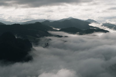 Scenic view of mountains against cloudy sky