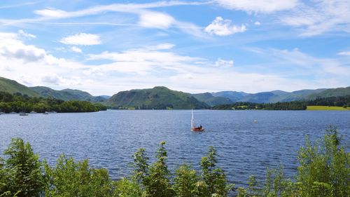 Scenic view of lake and mountains against sky