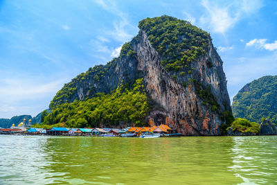 Scenic view of rock formation in sea against sky