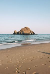 Scenic view of beach against clear sky