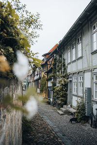 Street amidst buildings against clear sky