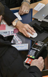 High angle view of man using smart phone on table